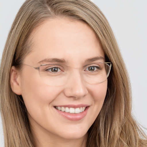 Joyful white young-adult female with long  brown hair and brown eyes