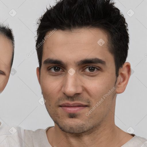 Joyful white young-adult male with short  black hair and brown eyes