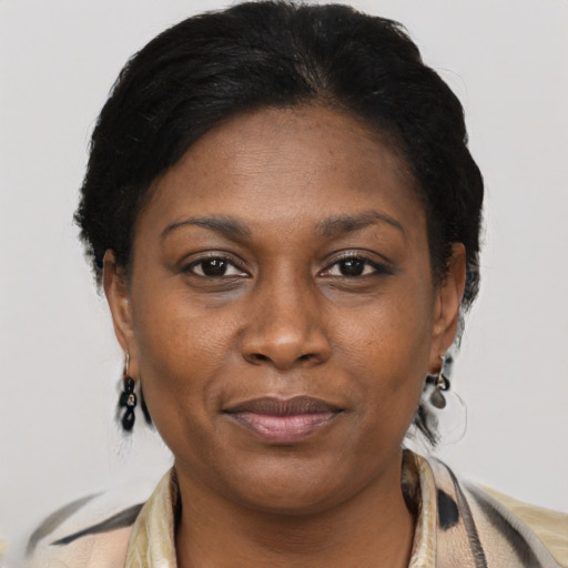 Joyful black adult female with medium  brown hair and brown eyes