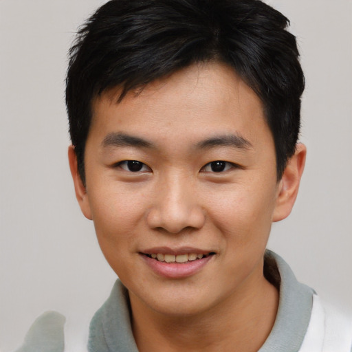 Joyful asian young-adult male with short  brown hair and brown eyes
