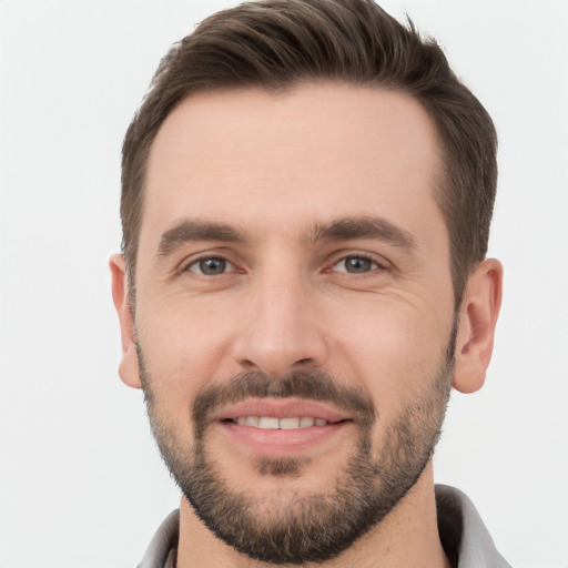 Joyful white young-adult male with short  brown hair and brown eyes