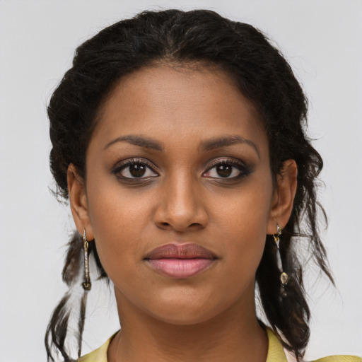 Joyful black young-adult female with medium  brown hair and brown eyes