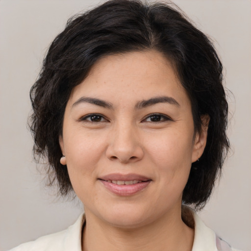 Joyful asian young-adult female with medium  brown hair and brown eyes
