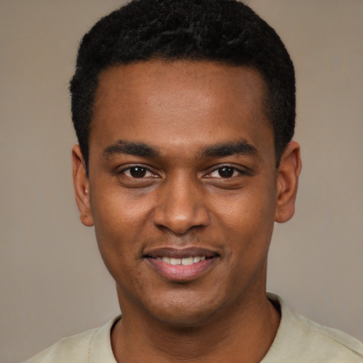 Joyful black young-adult male with short  black hair and brown eyes