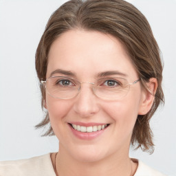 Joyful white young-adult female with medium  brown hair and grey eyes