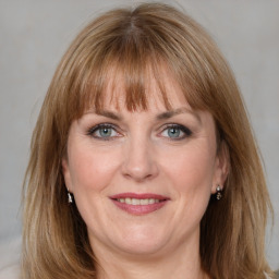 Joyful white adult female with medium  brown hair and grey eyes