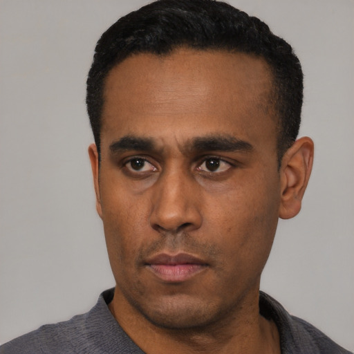 Neutral latino young-adult male with short  black hair and brown eyes