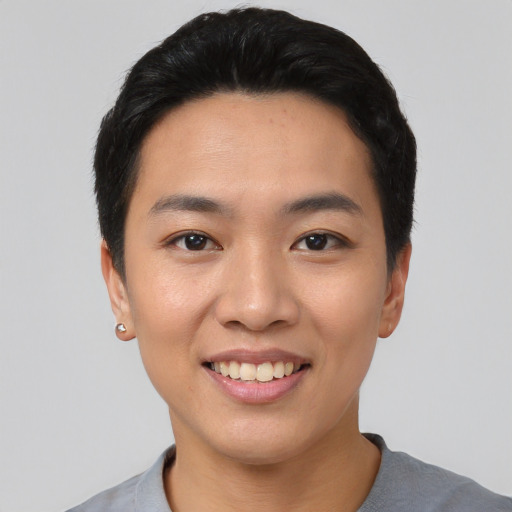 Joyful asian young-adult female with short  black hair and brown eyes