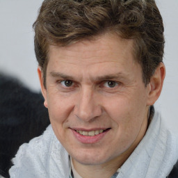 Joyful white adult male with short  brown hair and brown eyes