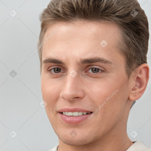 Joyful white young-adult male with short  brown hair and brown eyes