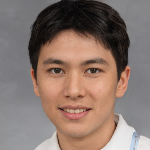Joyful asian young-adult male with short  brown hair and brown eyes