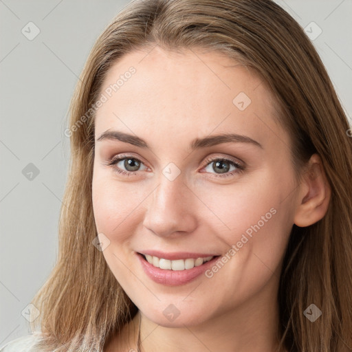 Joyful white young-adult female with long  brown hair and grey eyes