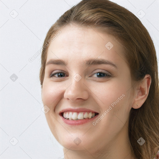 Joyful white young-adult female with long  brown hair and grey eyes