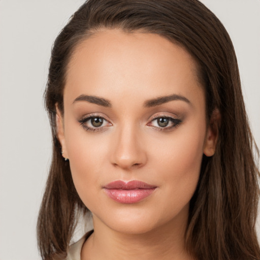 Joyful white young-adult female with long  brown hair and brown eyes