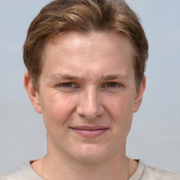 Joyful white adult male with short  brown hair and grey eyes