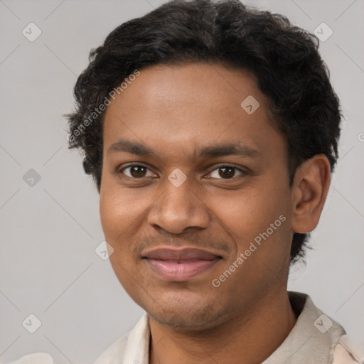 Joyful black young-adult male with short  brown hair and brown eyes