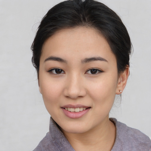 Joyful asian young-adult female with medium  brown hair and brown eyes