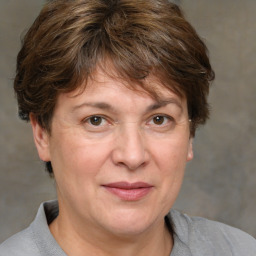 Joyful white middle-aged female with short  brown hair and brown eyes