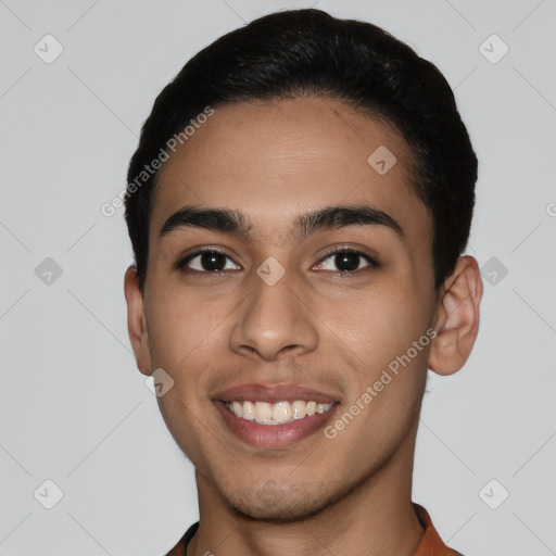 Joyful latino young-adult male with short  black hair and brown eyes