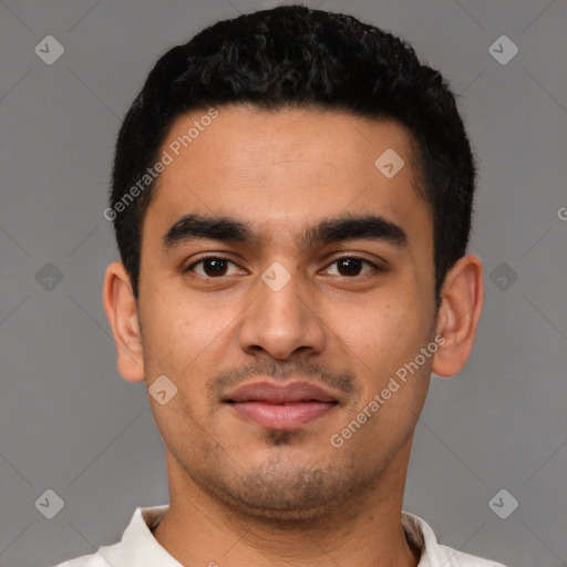 Joyful latino young-adult male with short  black hair and brown eyes