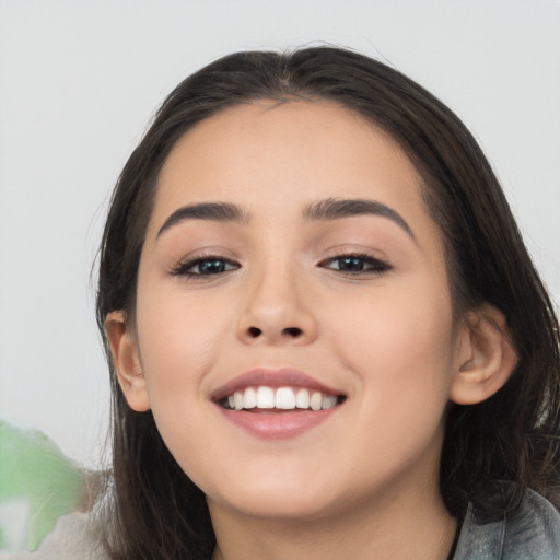 Joyful white young-adult female with long  black hair and brown eyes