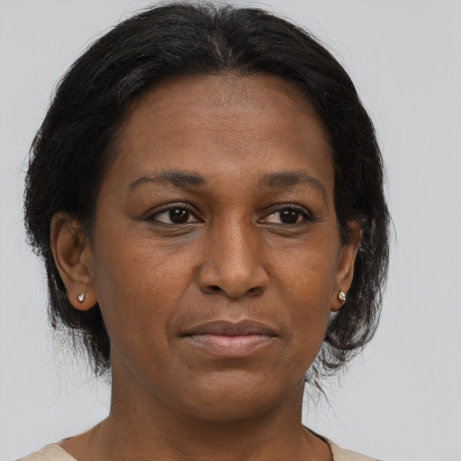Joyful black adult female with medium  brown hair and brown eyes