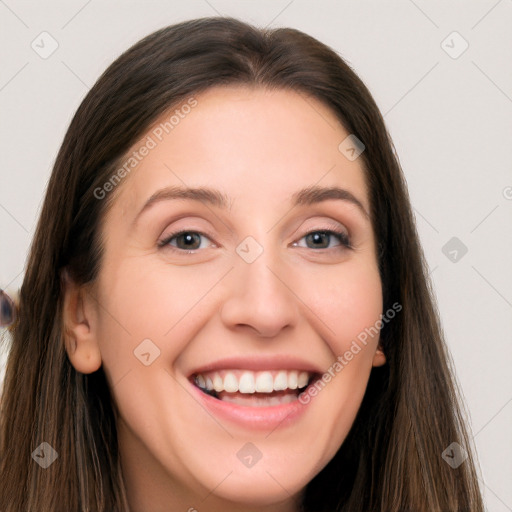 Joyful white young-adult female with long  brown hair and brown eyes