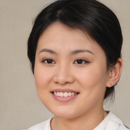 Joyful asian young-adult female with medium  brown hair and brown eyes