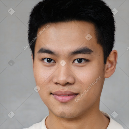 Joyful asian young-adult male with short  black hair and brown eyes