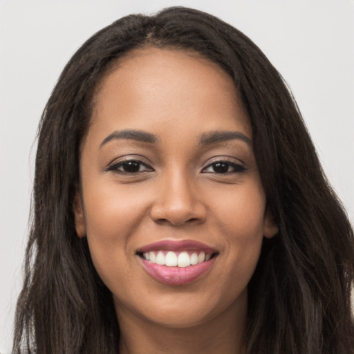 Joyful latino young-adult female with long  brown hair and brown eyes