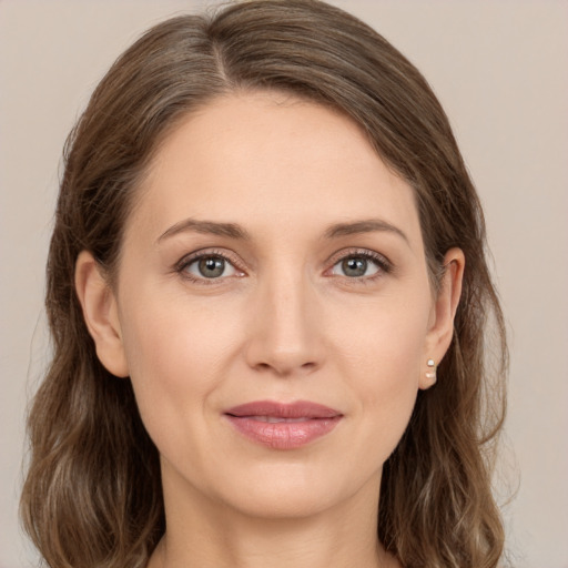 Joyful white young-adult female with medium  brown hair and grey eyes