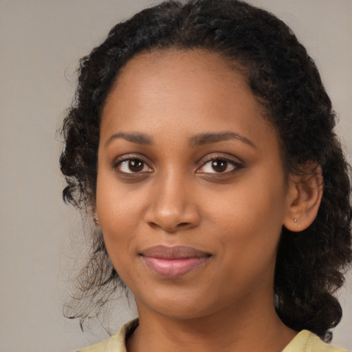 Joyful black young-adult female with medium  brown hair and brown eyes