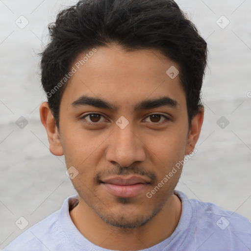 Joyful latino young-adult male with short  brown hair and brown eyes