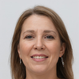 Joyful white adult female with long  brown hair and grey eyes