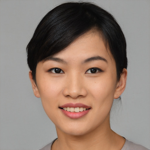 Joyful asian young-adult female with medium  black hair and brown eyes