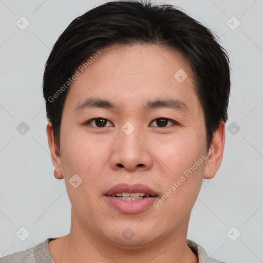 Joyful asian young-adult male with short  brown hair and brown eyes