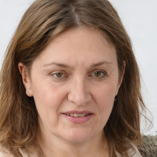 Joyful white adult female with long  brown hair and grey eyes