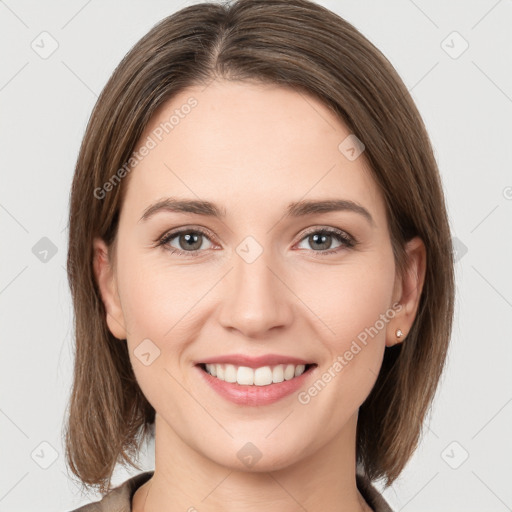 Joyful white young-adult female with medium  brown hair and grey eyes