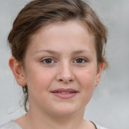 Joyful white child female with medium  brown hair and blue eyes