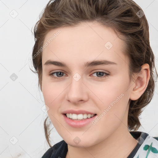 Joyful white young-adult female with medium  brown hair and green eyes