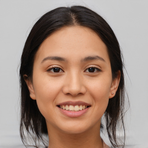 Joyful white young-adult female with medium  brown hair and brown eyes