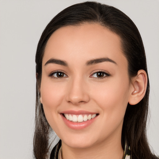 Joyful white young-adult female with long  brown hair and brown eyes