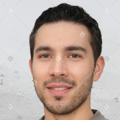 Joyful white young-adult male with short  black hair and brown eyes