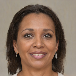 Joyful black adult female with medium  brown hair and brown eyes