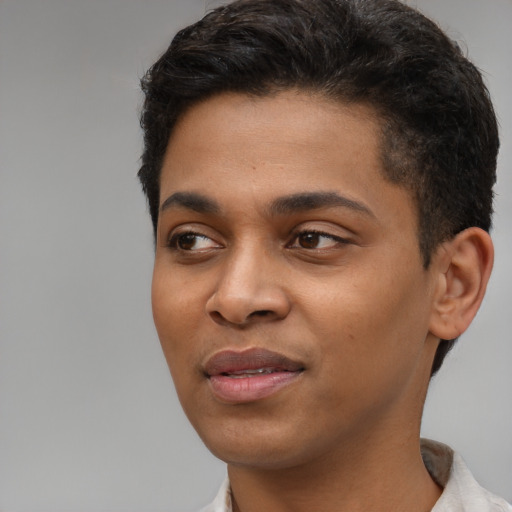 Joyful latino young-adult male with short  black hair and brown eyes