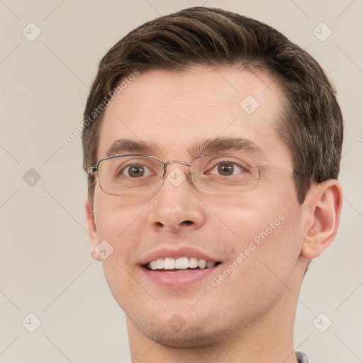 Joyful white young-adult male with short  brown hair and grey eyes