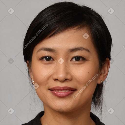 Joyful asian young-adult female with medium  black hair and brown eyes