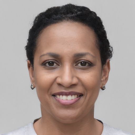 Joyful latino adult female with short  black hair and brown eyes