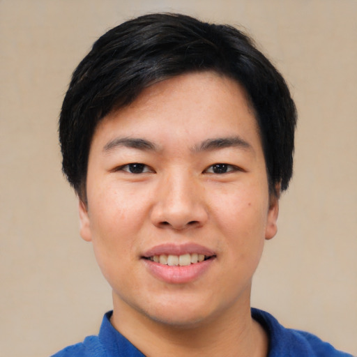Joyful asian young-adult male with short  black hair and brown eyes
