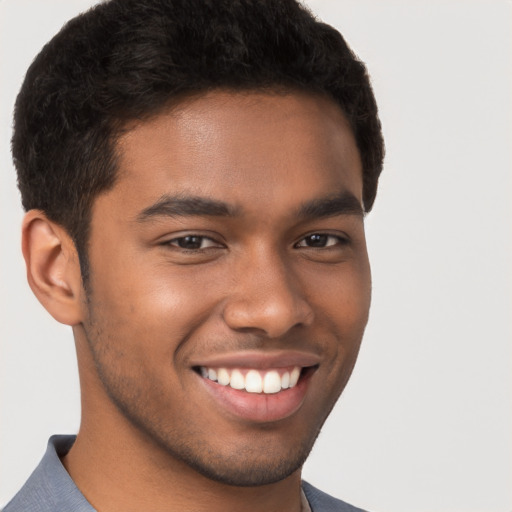 Joyful latino young-adult male with short  brown hair and brown eyes